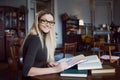 Young woman student of the University. Preparing exam and learning lessons in public library. Royalty Free Stock Photo