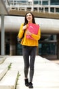 Young woman student walking with bag and books Royalty Free Stock Photo