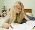 Young woman studying in bed Royalty Free Stock Photo