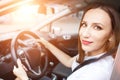 Young woman studying driving car in school