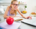 Young woman studying in kitchen Royalty Free Stock Photo