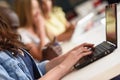 Young woman studying with laptop computer on white desk. Royalty Free Stock Photo