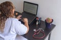 Young woman studying medicine sitting at a desk.