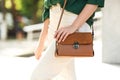 Young woman with stylish leather bag outdoors on day, closeup Royalty Free Stock Photo