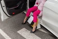 Young woman in stylish pink pants in black fashionable high-heeled shoes in elegant fur coat holds shopping bags in hand. Close up Royalty Free Stock Photo