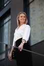 blond business woman standing in front of office building Royalty Free Stock Photo