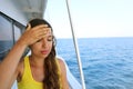 Young woman suffer from seasickness during vacation on boat.