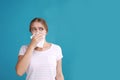 Young woman suffering from allergy on blue background Royalty Free Stock Photo