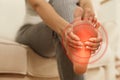 Young woman suffering from foot pain indoors, closeup