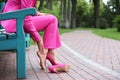 Young woman suffering from pain in legs because of uncomfortable shoes outdoors Royalty Free Stock Photo