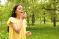 Young woman suffering from seasonal allergy outdoors
