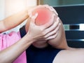 Young woman suffering from severe knee pain