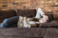 High angle view of young woman suffering from stomachache on sofa at home Royalty Free Stock Photo