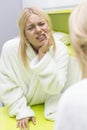 Young woman suffering from toothache while looking at mirror Royalty Free Stock Photo