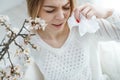 A woman suffers from allergies during the flowering period. Royalty Free Stock Photo