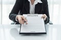 Young woman in suit in his office showing an insurance policy an Royalty Free Stock Photo