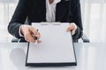 Young woman in suit in his office showing an insurance policy an Royalty Free Stock Photo