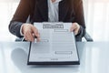 Young woman in suit in his office showing an insurance policy an Royalty Free Stock Photo