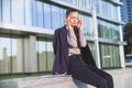 Young woman in suit settles herself down after stressful work