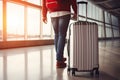 Young woman with suitcase at airport terminal. Travel and vacation concept. Close up of a man walking with luggage in airport. Royalty Free Stock Photo