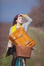 Young woman with suitcase and bike at outdoor countryside. Royalty Free Stock Photo