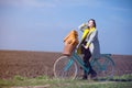 Young woman with suitcase and bike at outdoor countryside. Royalty Free Stock Photo