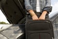 Young woman with suitcase next to the broken car ready to leave it Royalty Free Stock Photo