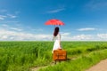 Young woman with suitcase and umbrella Royalty Free Stock Photo