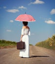Young woman with suitcase and umbrella Royalty Free Stock Photo
