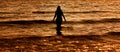 Young woman in summer dress standing in a sea Royalty Free Stock Photo