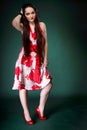 Young woman in summer flowery dress on green Royalty Free Stock Photo