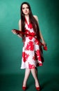 Young woman in summer flowery dress on green Royalty Free Stock Photo