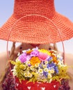 Young woman on the summer meadow with basket of