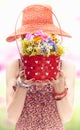 Young woman on the summer meadow with basket of