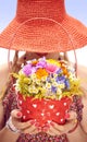 Young woman on the summer meadow with basket of