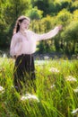 Young woman in summer sunny day walking and dancing in fields fl Royalty Free Stock Photo