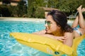 Young woman sun bathing in spa resort swiming pool Royalty Free Stock Photo