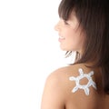 Young woman with sun-shaped sun cream Royalty Free Stock Photo