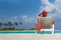 Young woman sunbathing on lounger at tropical beach Royalty Free Stock Photo