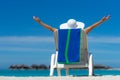 Young woman sunbathing on lounger at tropical beach Royalty Free Stock Photo