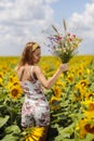Young woman on a sunflowers field Royalty Free Stock Photo