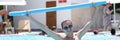 Young woman in sunglasses is engaged in aqua aerobics in outdoor pool