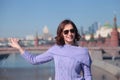Young woman in sunglasses on a glass bridge on the background of the Moscow Kremlin Royalty Free Stock Photo