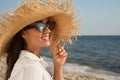 Young woman with sunglasses and hat at beach. Sun protection care Royalty Free Stock Photo