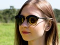 Young woman in sunglasses on the nature, sunflower reflected in glasses Royalty Free Stock Photo