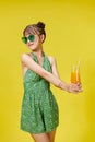 Young woman with sunglasses smiling cheerful and holding a glass of orange juice in summer Royalty Free Stock Photo