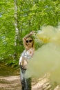 Young woman in sunglasses and summer clothes using smoke bomb Royalty Free Stock Photo