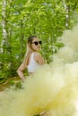 Young woman in sunglasses and summer clothes using smoke bomb Royalty Free Stock Photo