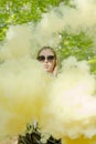 Young woman in sunglasses and summer clothes using smoke bomb Royalty Free Stock Photo