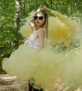 Young woman in sunglasses and summer clothes using smoke bomb Royalty Free Stock Photo